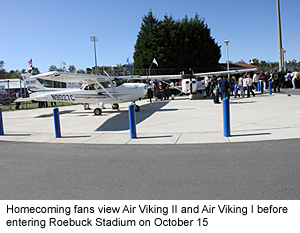 Homecoming fans view Air Viking I and Air Viking II at Roebuck Stadium