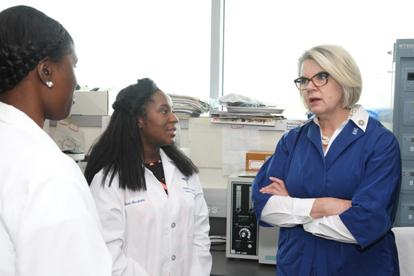 Student researchers talk to UNC President Margaret Spellings.